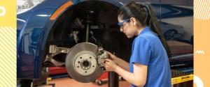 female auto tech working on the car brake